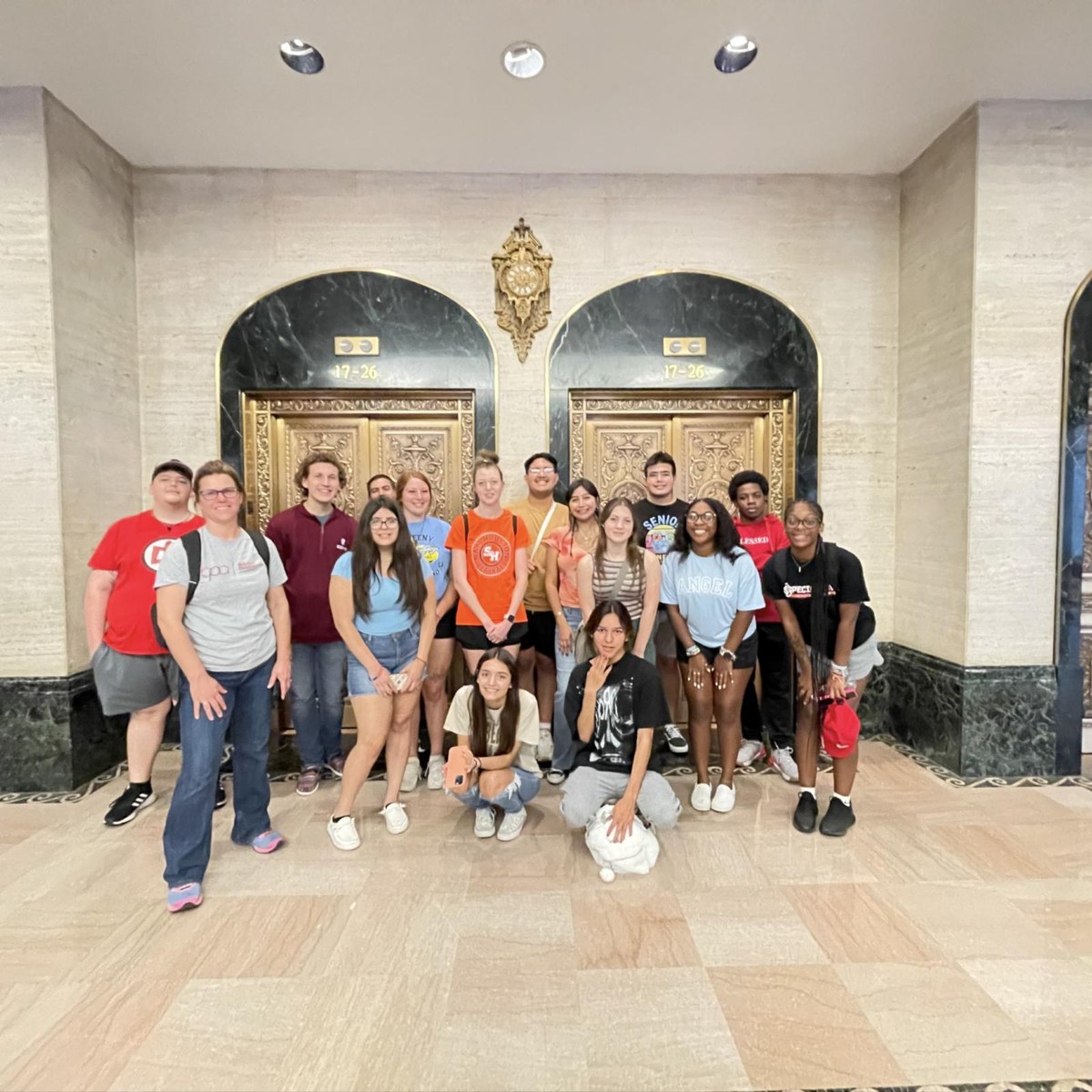 An Astroville tour group in a historic downtown Houston building lobby