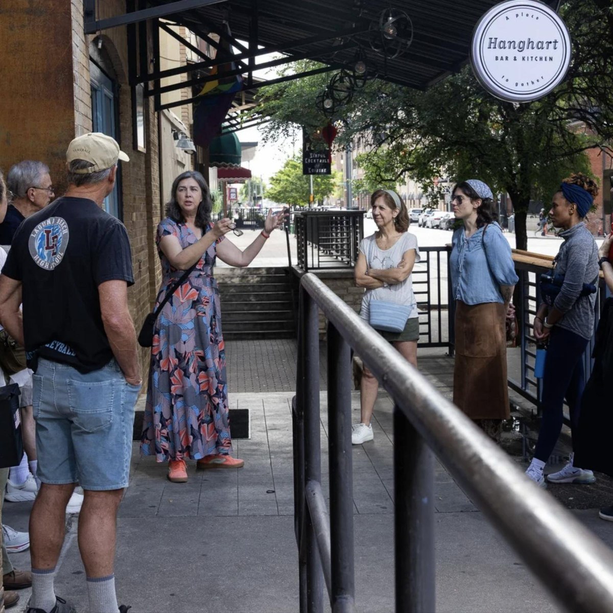 A Nitty Gritty City Tours guide speaking to a group on a downtown Austin sidewalk