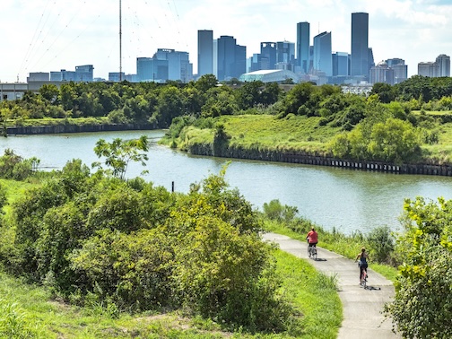 Walkers standing in front of Houston is Inspired mural